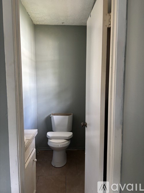 A white toilet in a small bathroom.