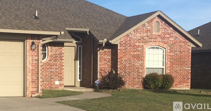A house with a brick facade and a garage door.