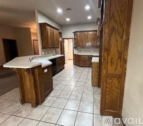 A kitchen with wooden cabinets and a white countertop.