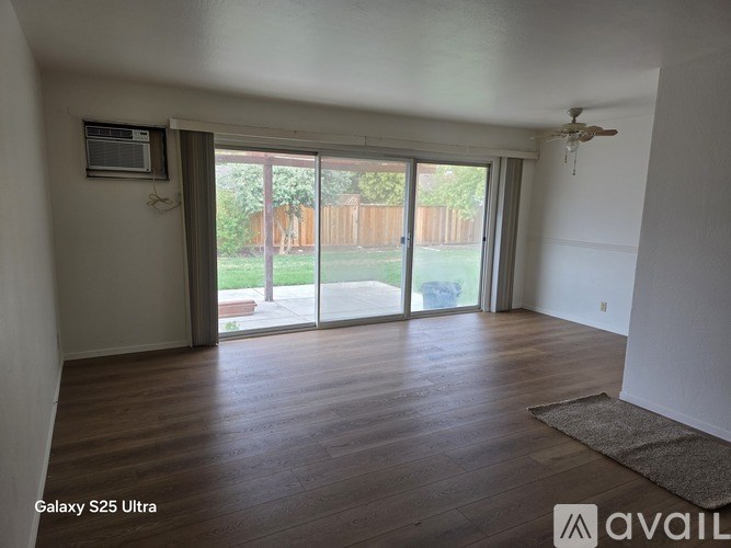 A room with a Galaxy S25 Ultra TV mounted on the wall.