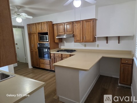 A kitchen with wooden cabinets and a white countertop.