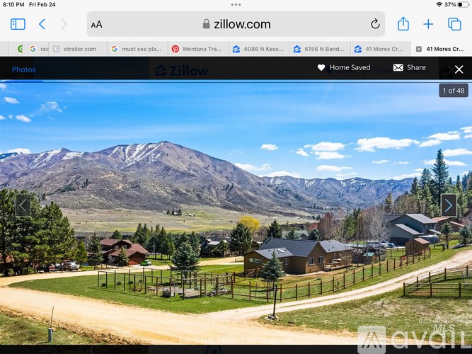 A webpage displays a photo of a mountainous landscape with houses and a clear sky.