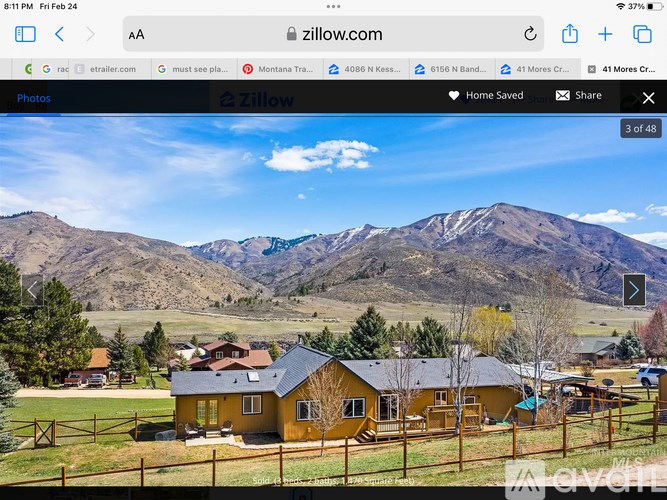 A yellow house with a mountain in the background.