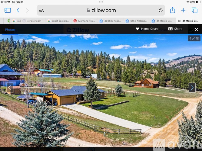 A webpage displays a real estate listing for a property with a large front yard and a cabin-like building.