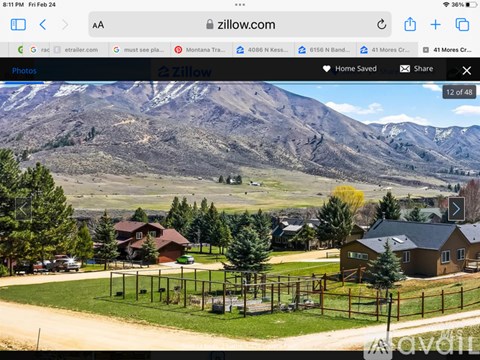 A mountainous landscape with houses and a playground in the foreground.