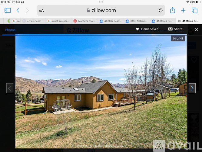 A yellow house with a mountain in the background.