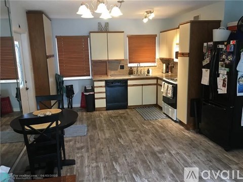 A kitchen with a table and chairs in the middle of the room.