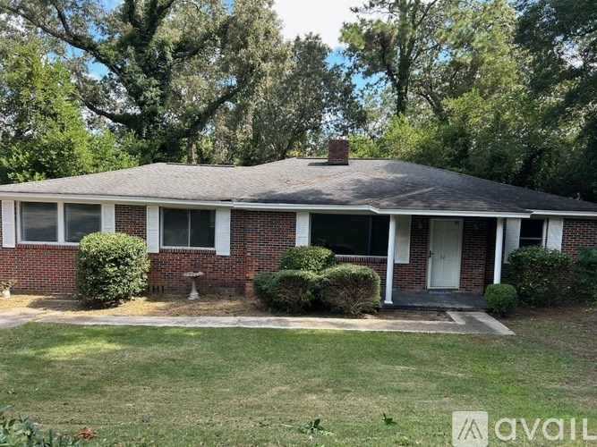 A house with a brick facade and a gabled roof.