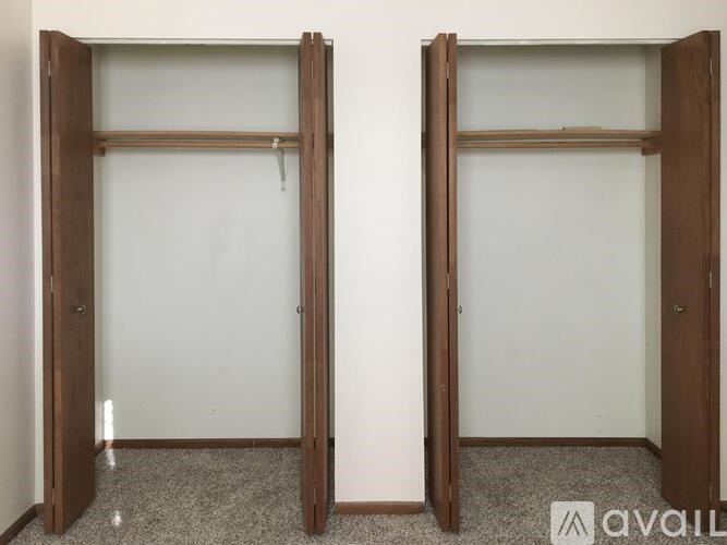 Two open wooden doors with glass panels.