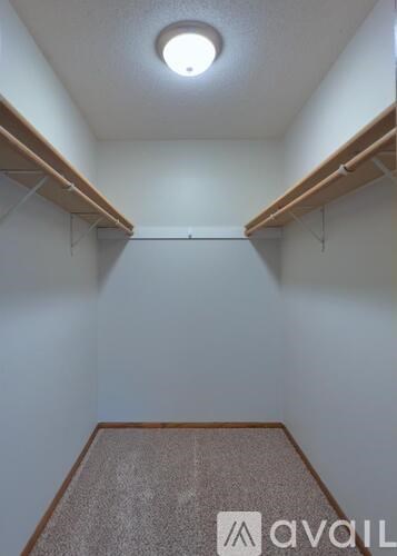 A room with a carpeted floor and a ceiling light.