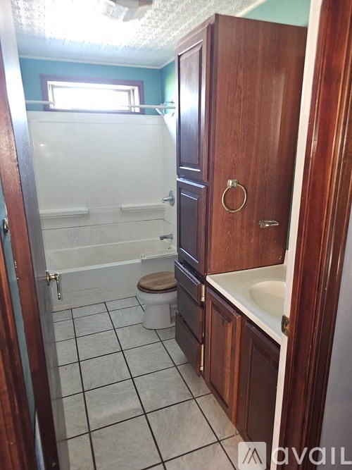 A bathroom with a toilet, sink, and shower.