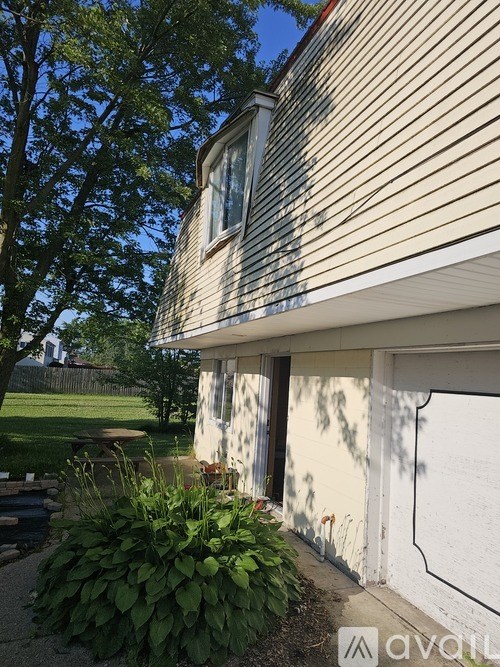 A house with a white wall and a window.