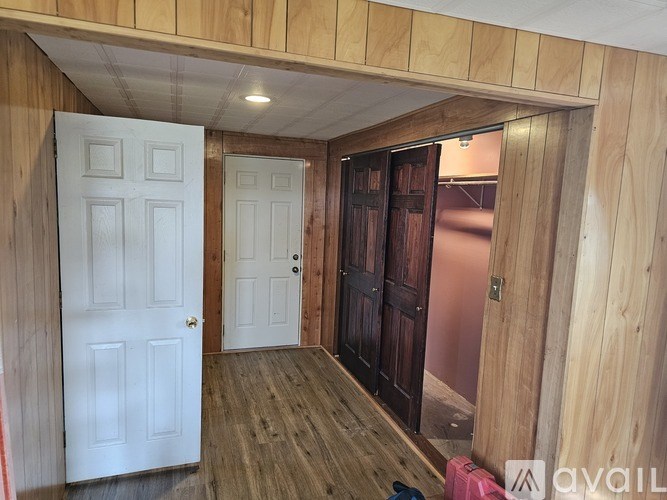 A room with a white door and a brown door.