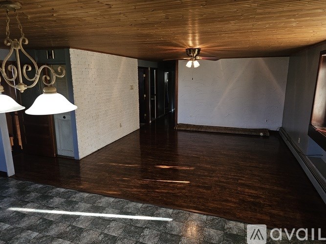 A room with a wooden ceiling and a checkered floor.