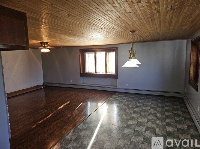 A room with wooden floors and a checkered floor mat.
