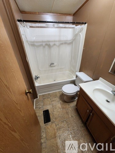 A bathroom with a toilet, sink, and shower.