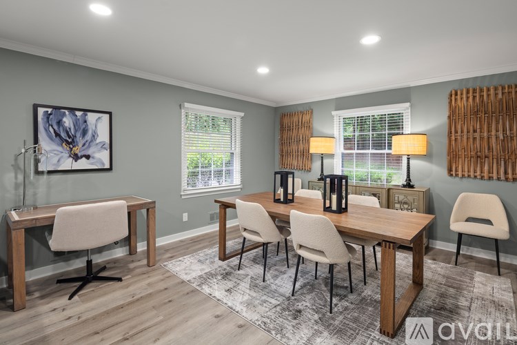 A dining room with a wooden table and chairs.