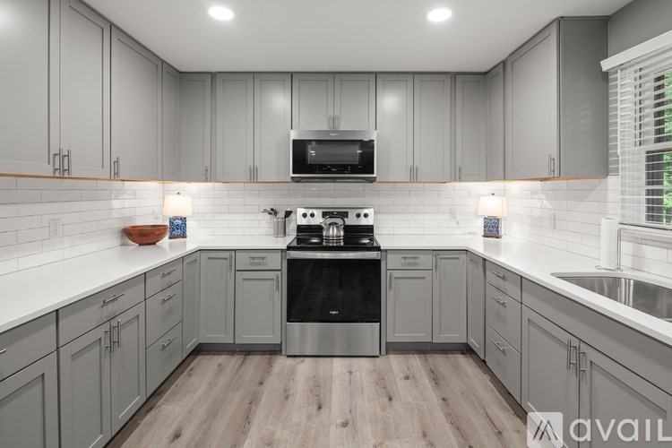 A modern kitchen with a stove top oven and a microwave above the stove.