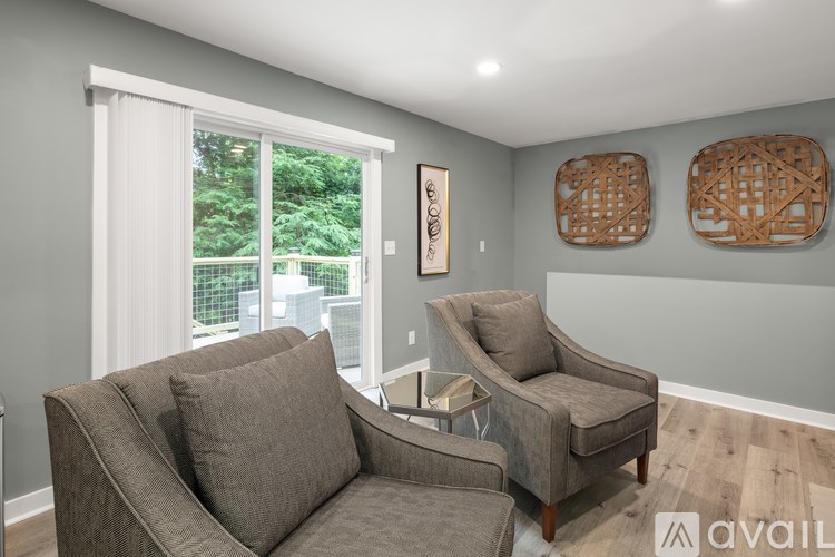 A living room with two grey couches and a wooden table.