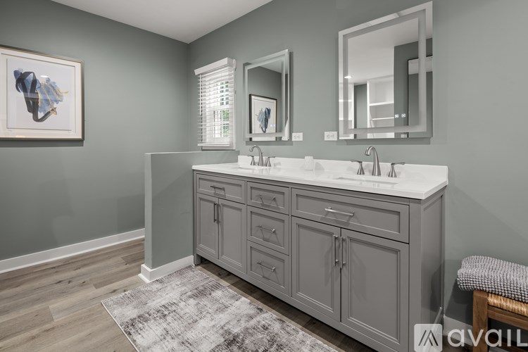 A bathroom with a vanity and a mirror above it.
