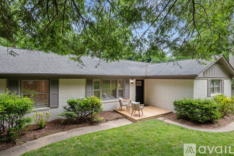 A house with a patio and a tree branch hanging over it.
