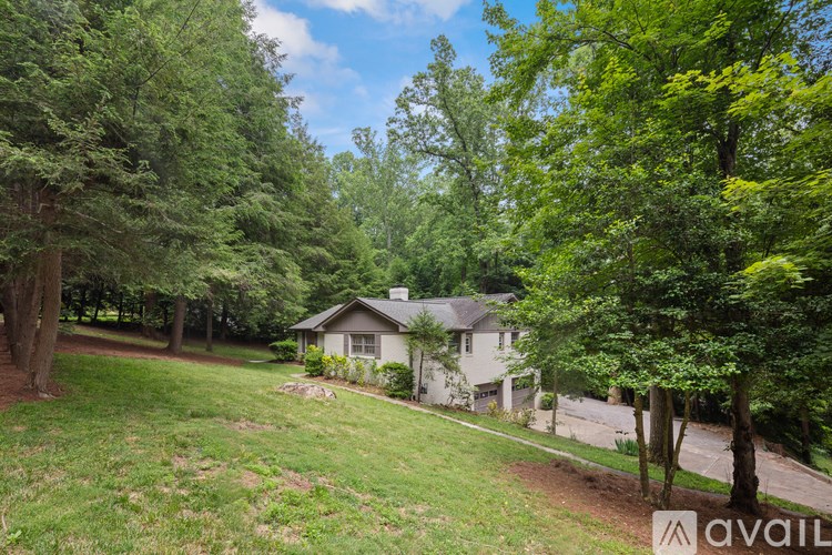 A house is surrounded by trees and grass.