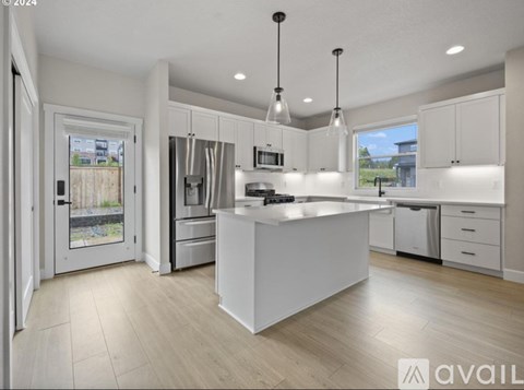 A modern kitchen with a large island in the center.