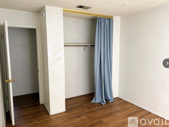 A room with a door and a curtain.
