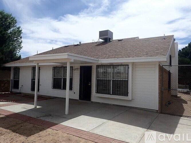 A house with a white exterior and a brown roof is for sale.