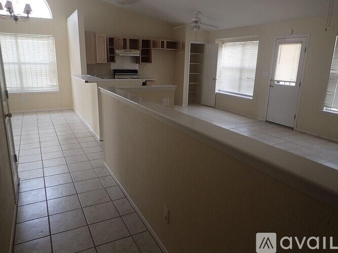 A kitchen area with a counter and cabinets.