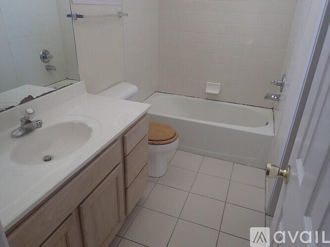 A bathroom with a toilet, sink, and bathtub.