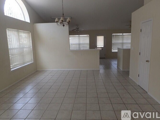 Empty room with tiled floor and white walls.