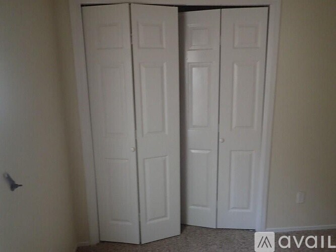 Two white doors in a room.