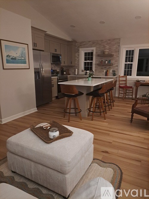 A kitchen with a refrigerator, microwave, and oven.