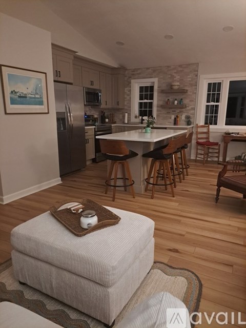 A kitchen with a refrigerator, microwave, and oven.