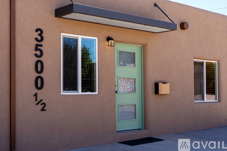 A house with a green door and a number 3500 on the wall.