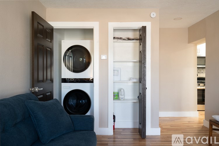 A modern kitchen with a washing machine built into the cabinetry.