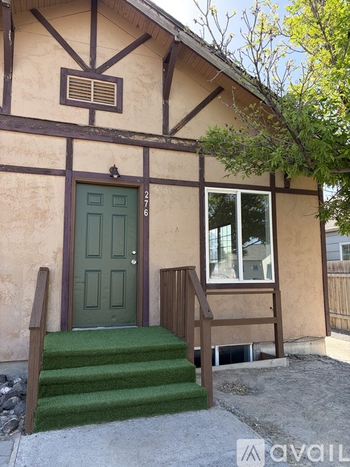A small house with a brown door and a brown roof.