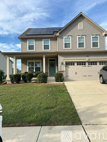 A house with a solar panel on the roof.