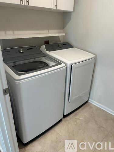A white washing machine and dryer in a laundry room.