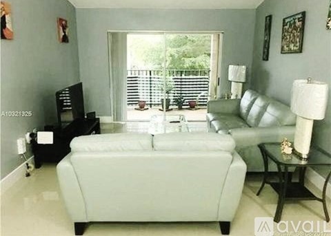A living room with a white sofa and a black television.