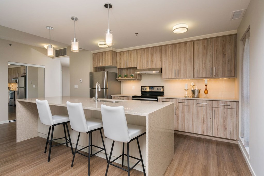 A kitchen with a white table and chairs.