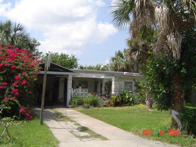 A house with a white picket fence and a tree in front.