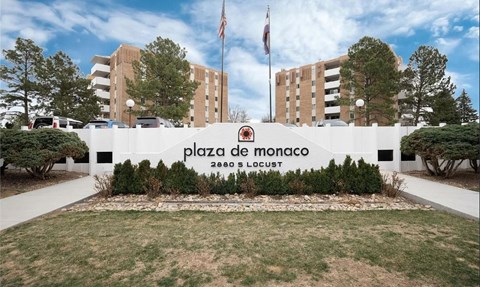 Plaza de Monaco sign in front of a building.