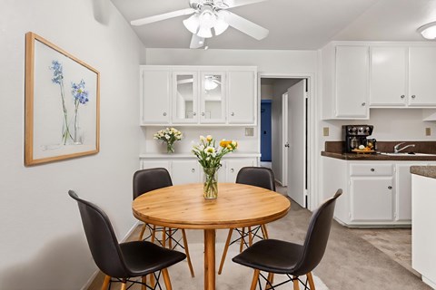 A dining room with a round table and chairs.