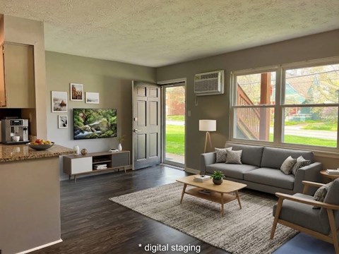 A living room with a grey couch and a coffee table.