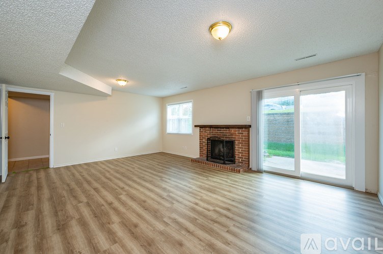 A living room with a fireplace and sliding glass doors.