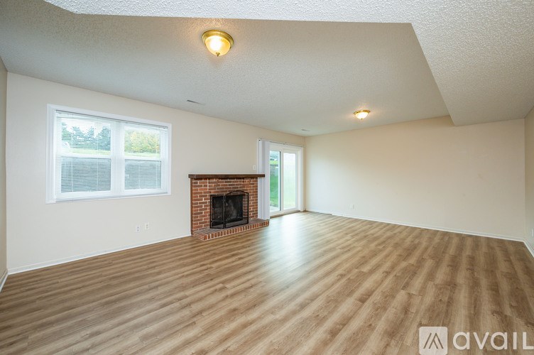 A room with a fireplace and a window.