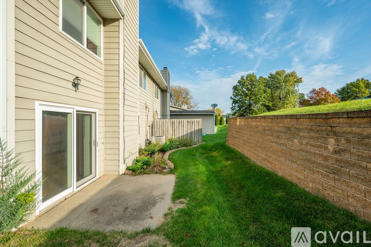 A house with a brown fence and a green lawn.