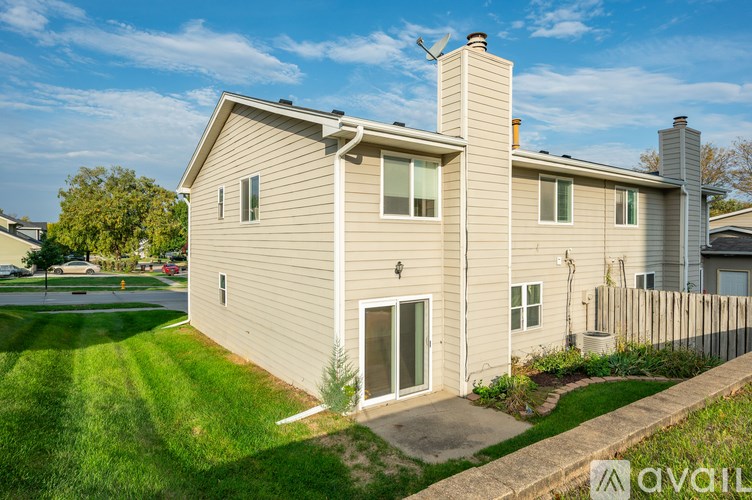 A house with a beige exterior and a white fence.